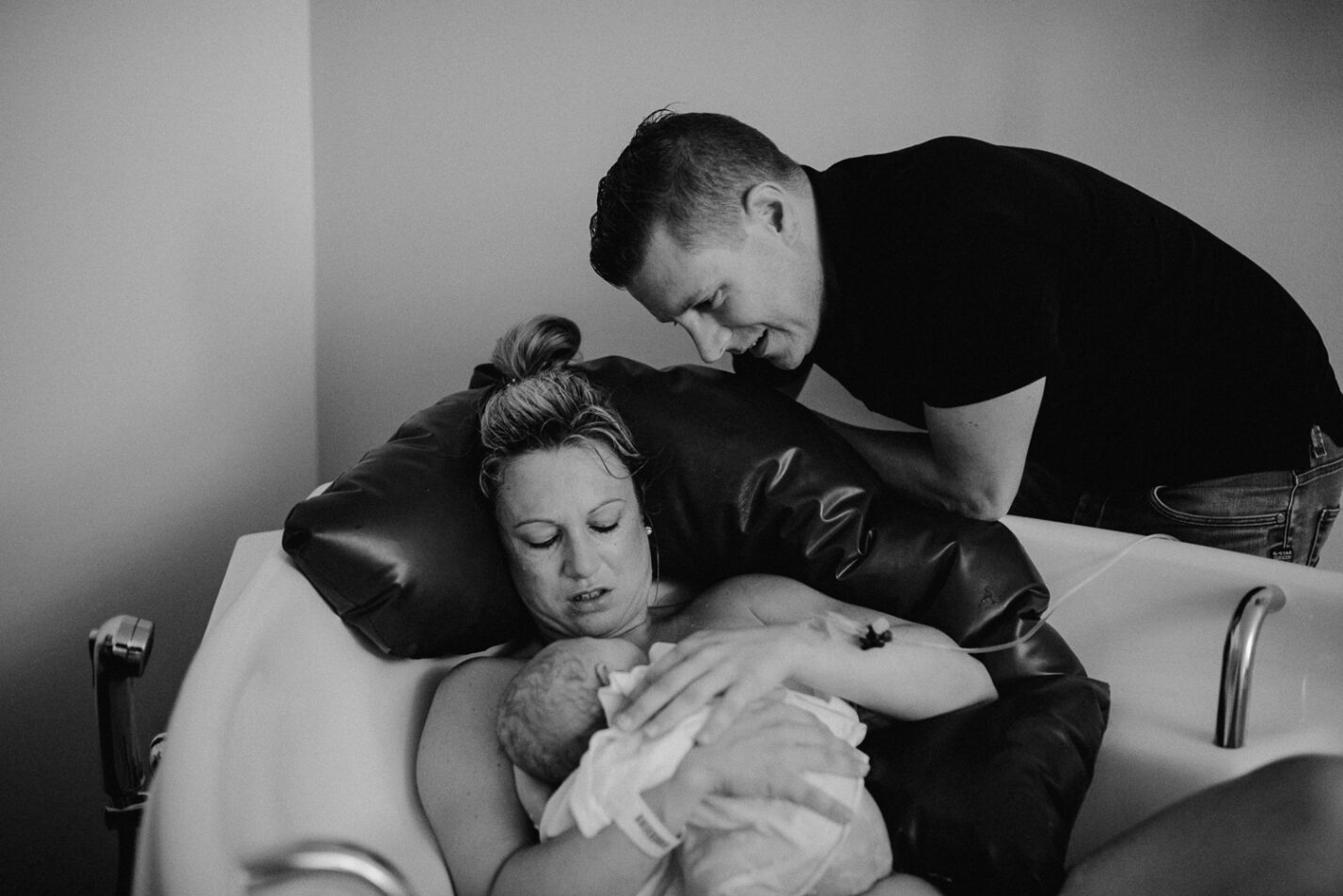 Mama hält frischgeborenes Baby im Arm
